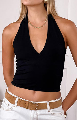 blonde girl wearing a lack halter tank top paired with white jeans