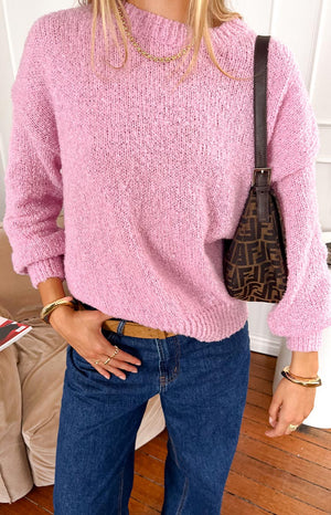 model wearing a pink knitted sweater styled with jeans and gold jewellery