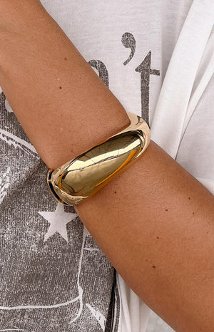 oversized gold cuff bracelet styled on model