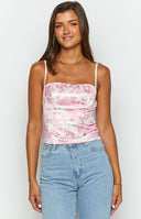 Pink printed top with low back cut on a brunette model