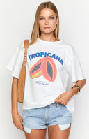 Model wearing a white oversized t shirt with a tropical fruit graphic print